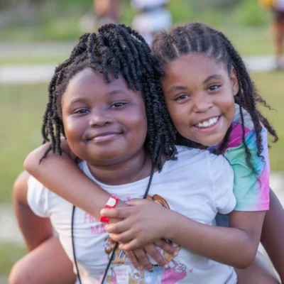 two girls smiling at the camera