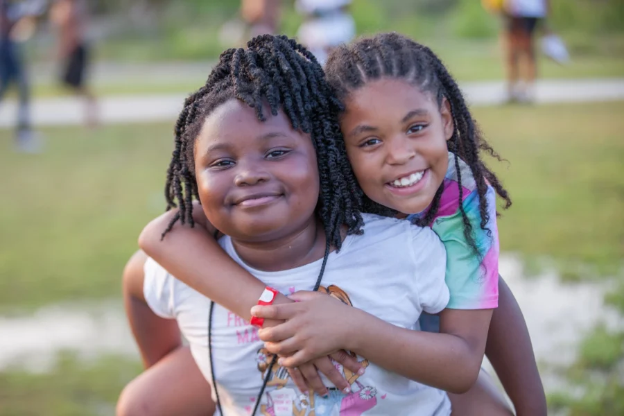 two girls smiling at the camera