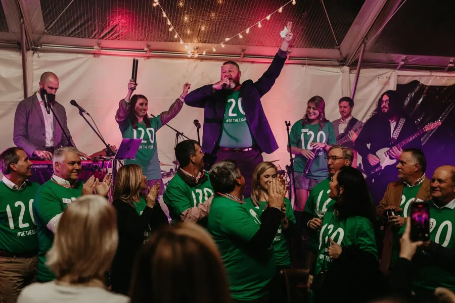 Board members and donors celebrate during the Be the Light event