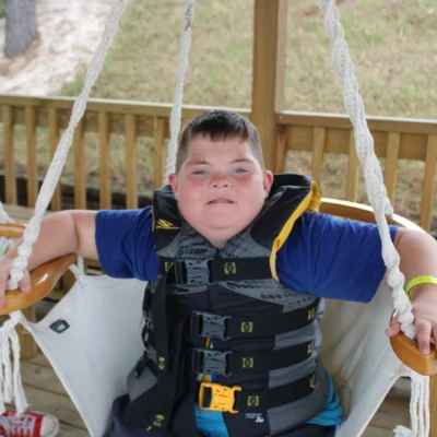 A camper hangs out in a swing