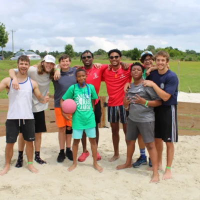 Counselors and campers pose with a ball