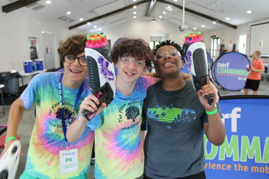 Three campers pose with Nerf toys
