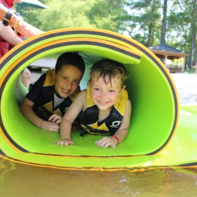 Children wrapped up in a pool floaty